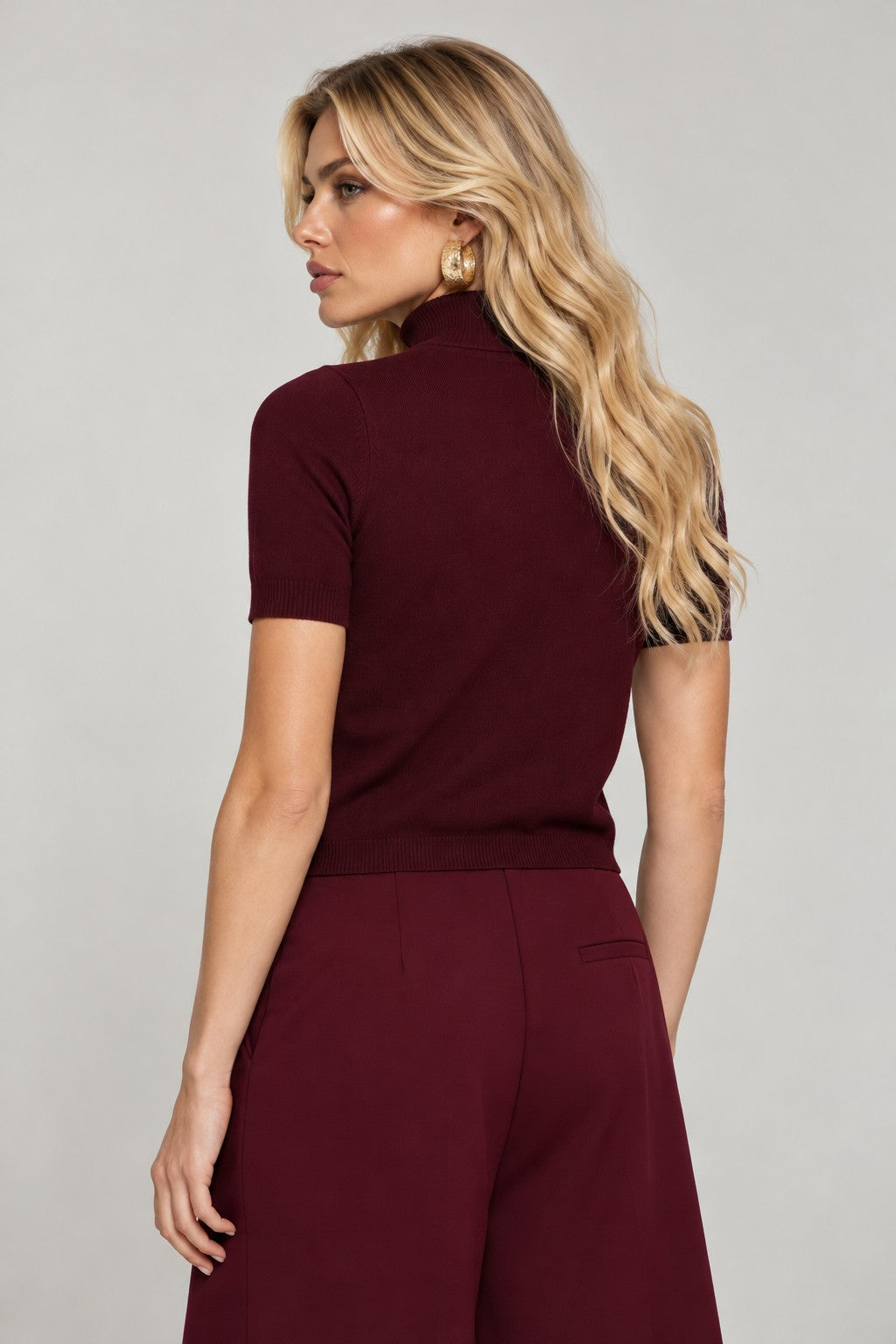 black knit top with short sleeves and high neckline